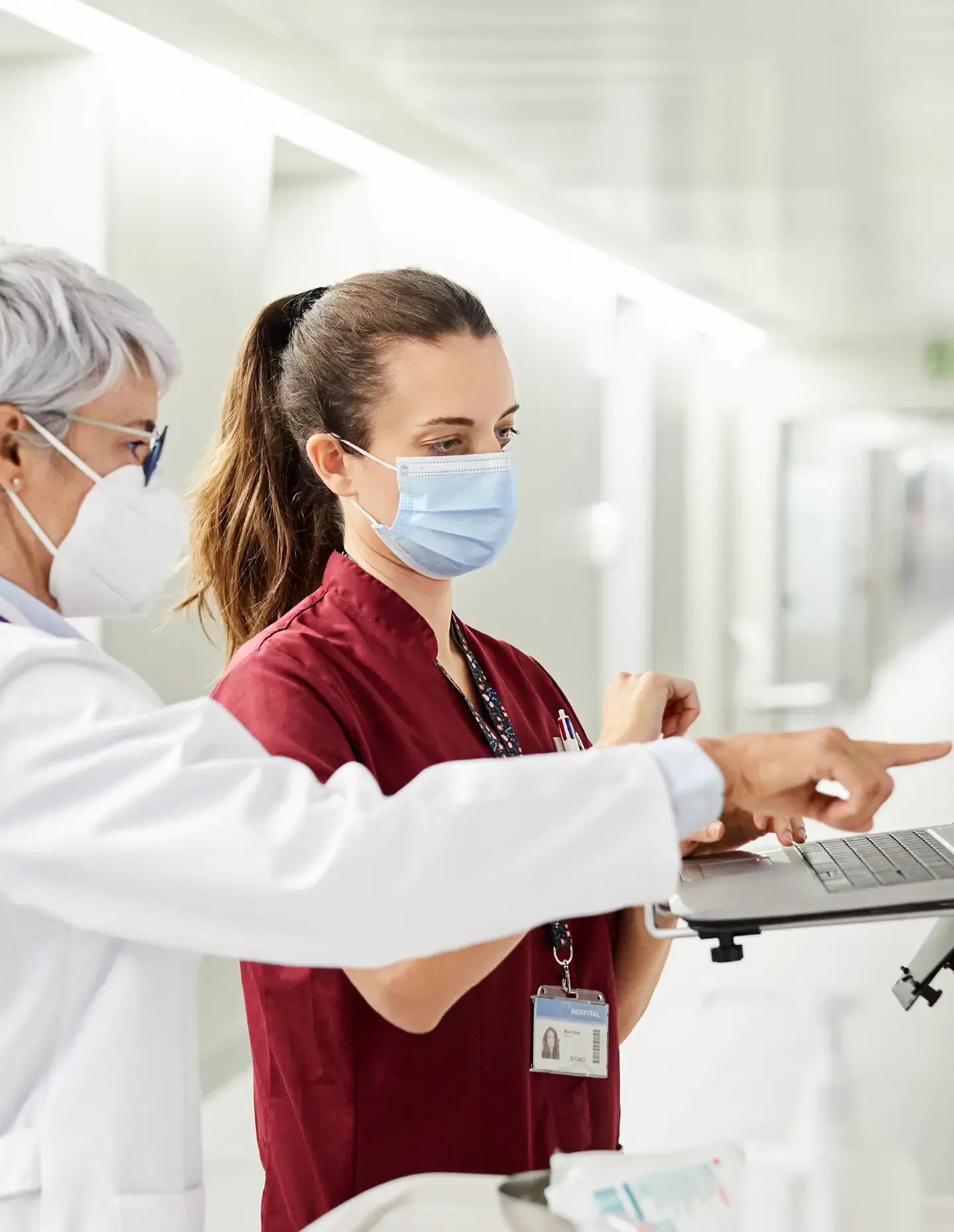 Scientist dropping solution into test tube Two healthcare providers looking at a computer screen
